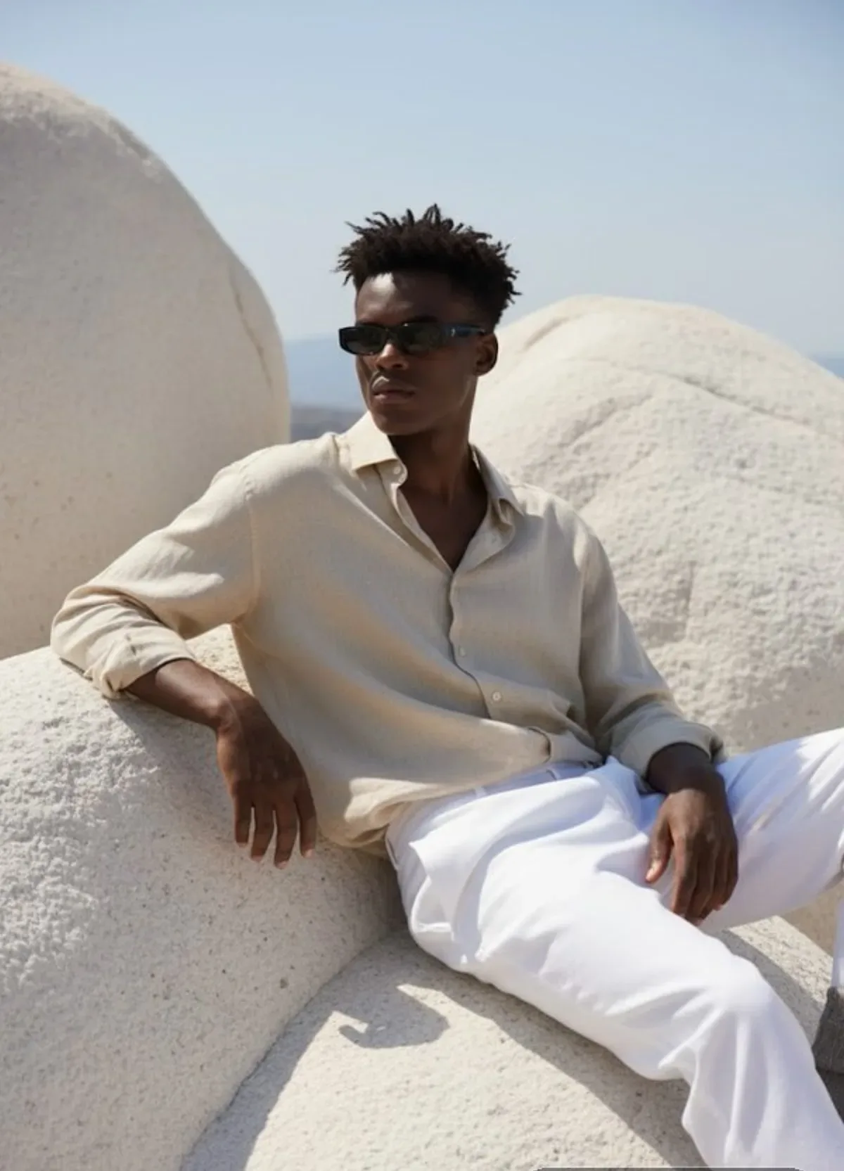 A Hyper-realistic Portrait Of A Young Man Sitting On Large